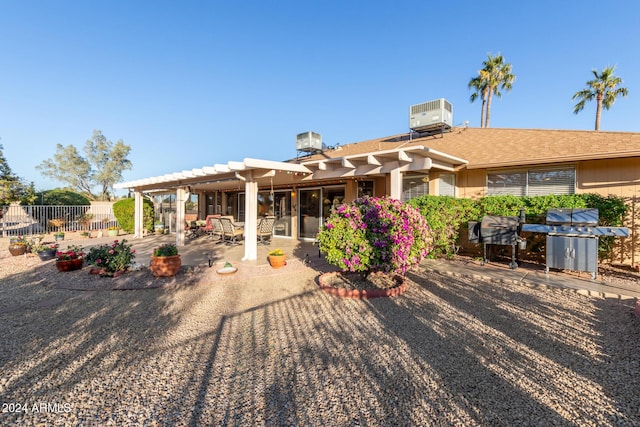 rear view of house with a pergola, central AC, and a patio area