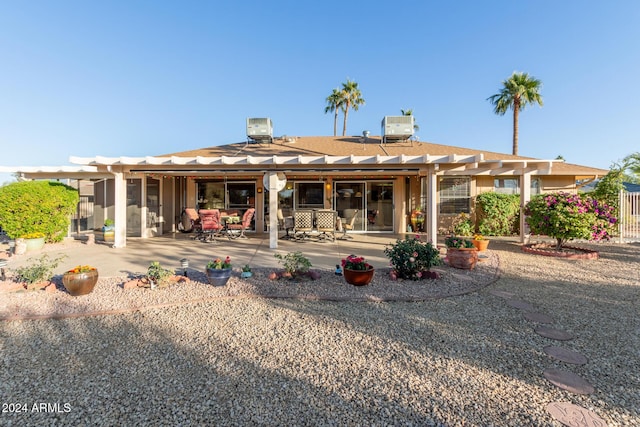 rear view of property with a pergola and a patio area