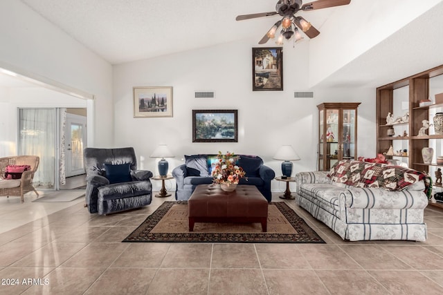 living room featuring ceiling fan, tile patterned flooring, and vaulted ceiling