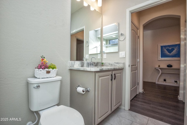 bathroom featuring vanity, tile patterned flooring, and toilet