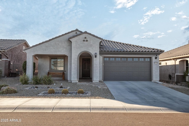 mediterranean / spanish-style house with a garage