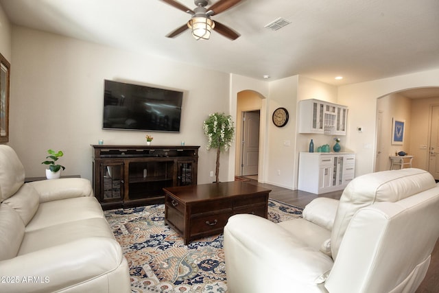 living room with hardwood / wood-style flooring and ceiling fan