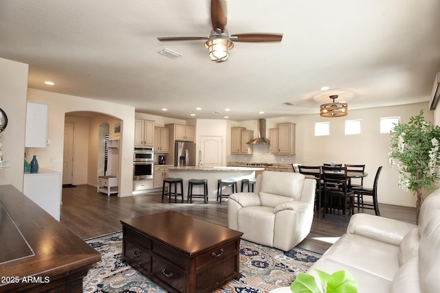 living room with ceiling fan, sink, and dark hardwood / wood-style flooring