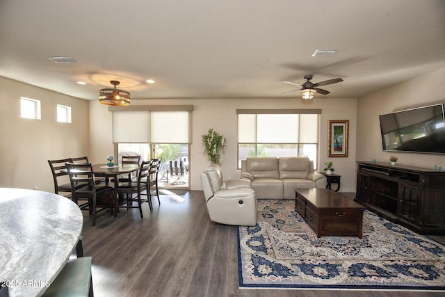 living room with dark hardwood / wood-style floors and ceiling fan