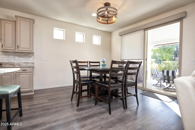 dining area featuring plenty of natural light, dark hardwood / wood-style flooring, and a notable chandelier