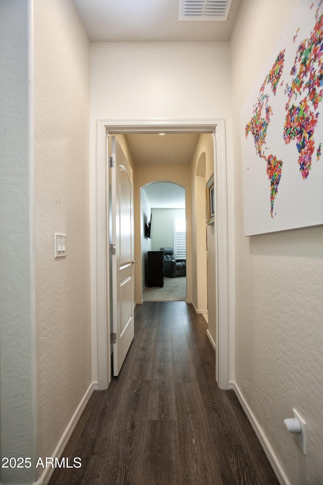 corridor with dark hardwood / wood-style floors