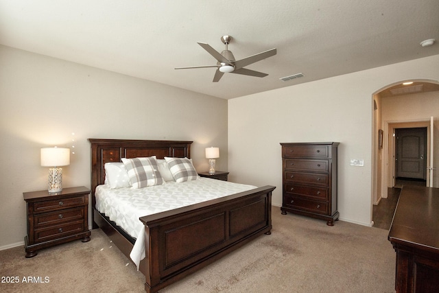 bedroom with ceiling fan and light carpet