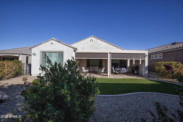 back of property with a lawn and a patio