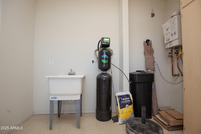 utility room featuring water heater