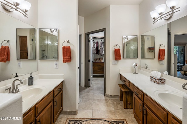 bathroom featuring tile patterned flooring, vanity, and a notable chandelier