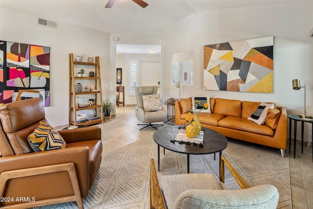 living room with ceiling fan, light tile patterned flooring, and vaulted ceiling