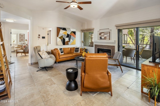 living room with ceiling fan, light tile patterned floors, and lofted ceiling