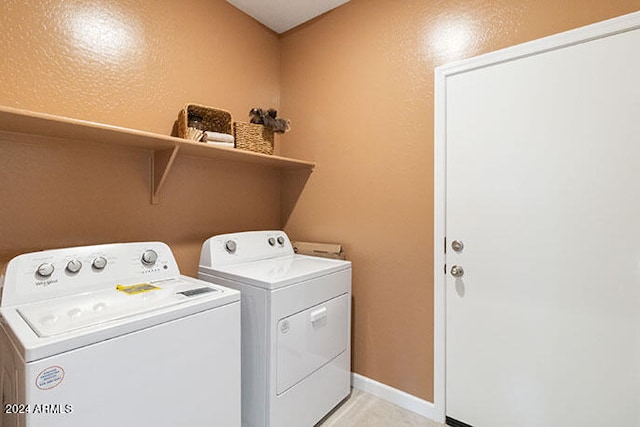 laundry room featuring washing machine and dryer, laundry area, and baseboards