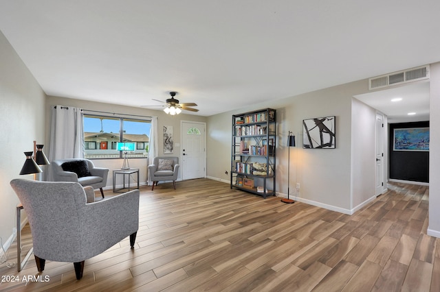 living area featuring hardwood / wood-style flooring and ceiling fan