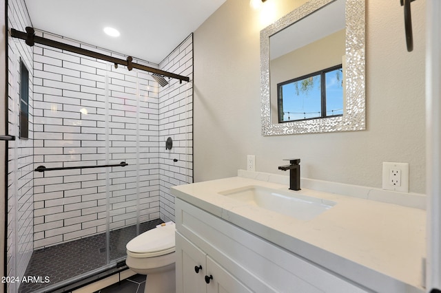 bathroom featuring vanity, toilet, and a shower with shower door