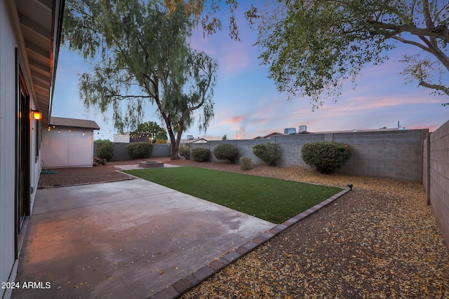 yard at dusk with a patio