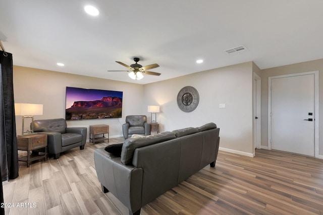 living room with ceiling fan and hardwood / wood-style floors