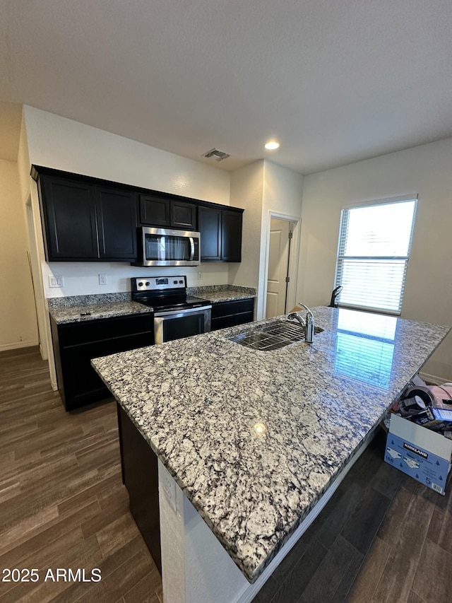 kitchen featuring a sink, visible vents, dark wood-type flooring, and appliances with stainless steel finishes