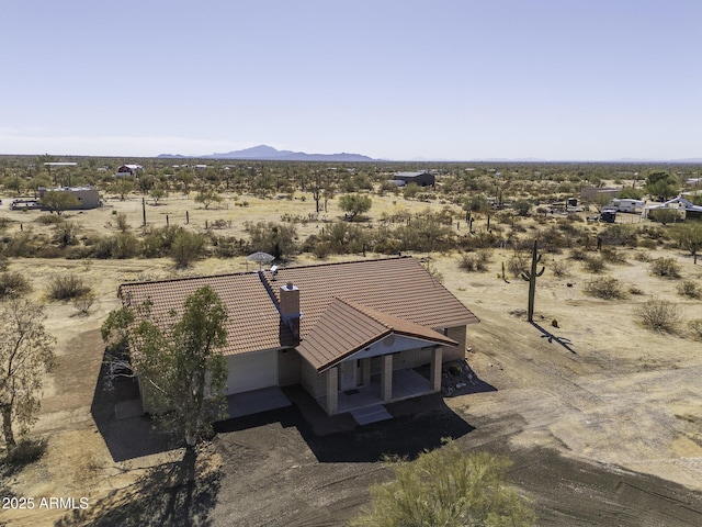 birds eye view of property with a mountain view and a rural view