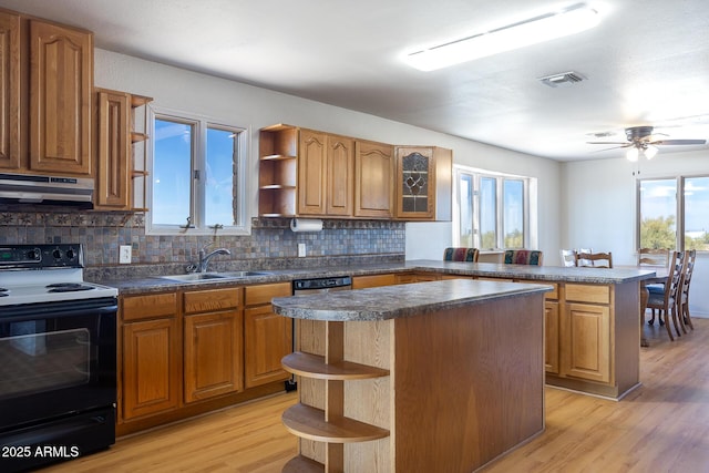 kitchen with under cabinet range hood, a kitchen island, electric range, and open shelves