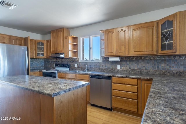 kitchen featuring under cabinet range hood, electric stove, stainless steel dishwasher, open shelves, and glass insert cabinets