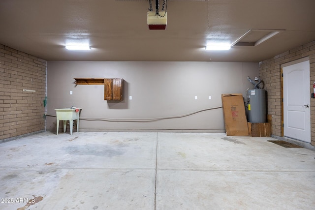 garage with water heater, a sink, and a garage door opener