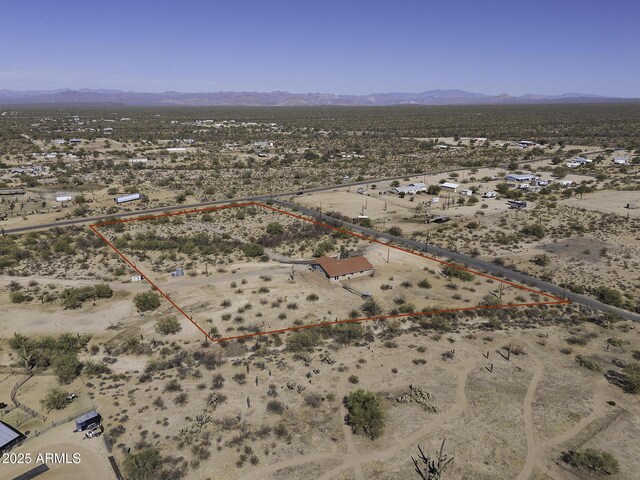 birds eye view of property featuring a desert view and a mountain view