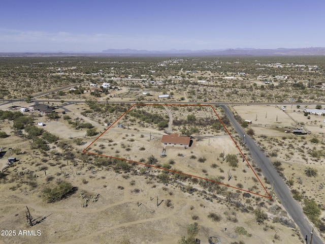 birds eye view of property with view of desert and a mountain view