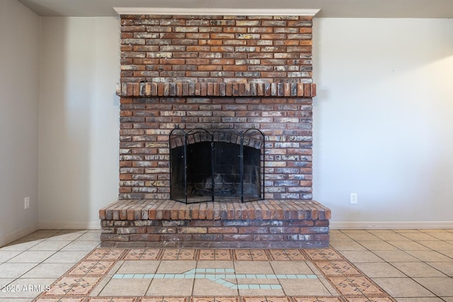 interior details with a brick fireplace and baseboards