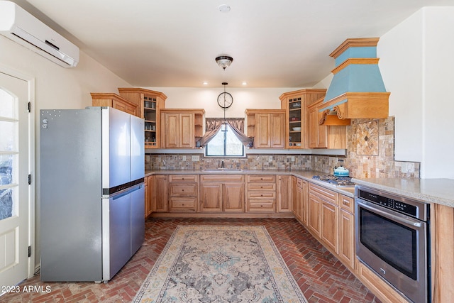 kitchen featuring a wall mounted air conditioner, sink, backsplash, and appliances with stainless steel finishes