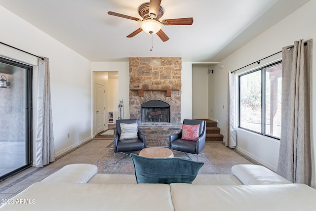 living room with ceiling fan, a fireplace, and light tile patterned flooring