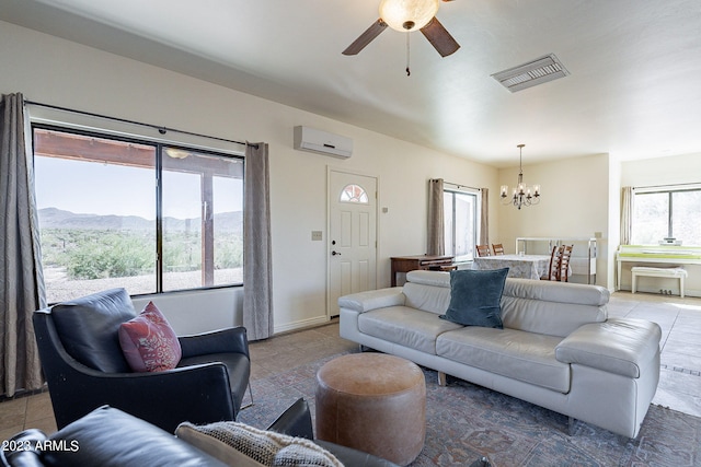 tiled living room with an AC wall unit, a mountain view, and ceiling fan with notable chandelier