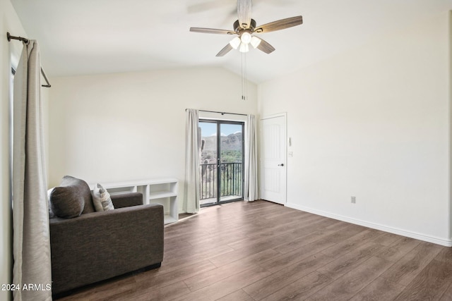 living area with ceiling fan, hardwood / wood-style floors, and vaulted ceiling