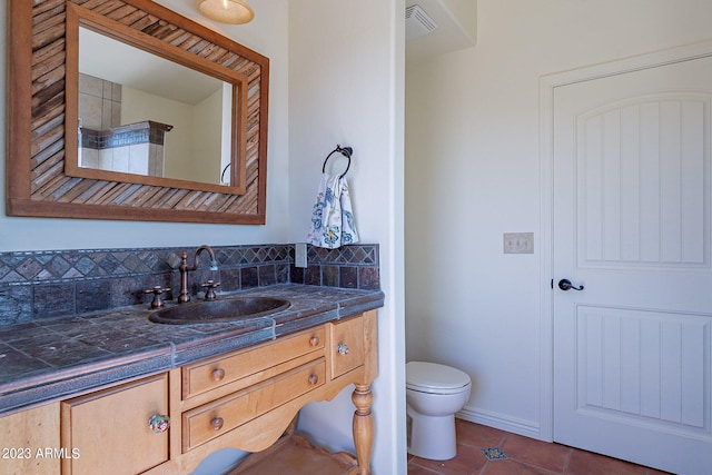 bathroom with tile patterned floors, vanity, and toilet