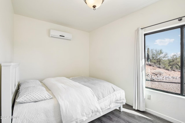 bedroom featuring dark hardwood / wood-style floors and a wall mounted AC