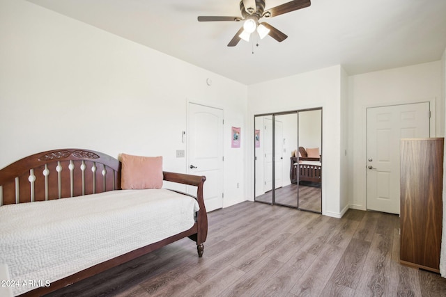 bedroom with light hardwood / wood-style flooring and ceiling fan