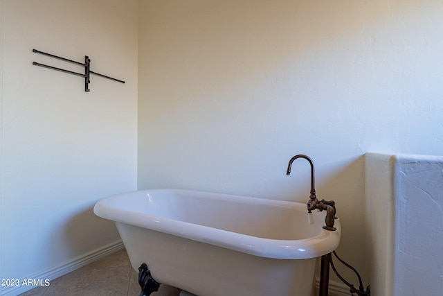 bathroom with a tub and tile patterned flooring