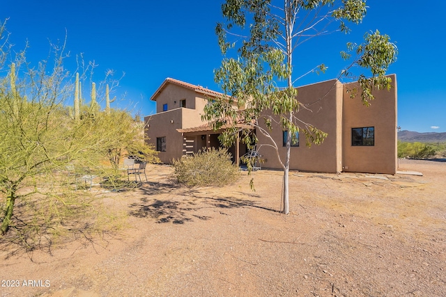 rear view of property featuring a mountain view