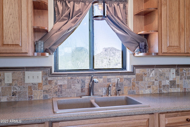 kitchen featuring sink, backsplash, and a wealth of natural light