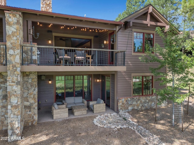 rear view of house with a balcony, outdoor lounge area, and a patio