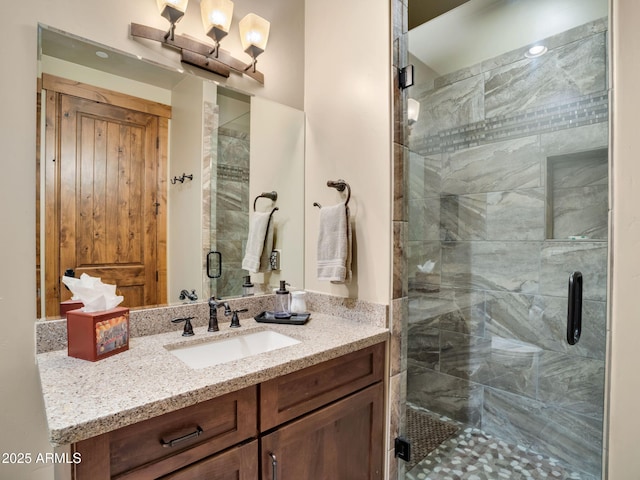 bathroom featuring an enclosed shower and vanity