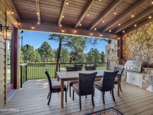 deck at dusk with grilling area and a lawn