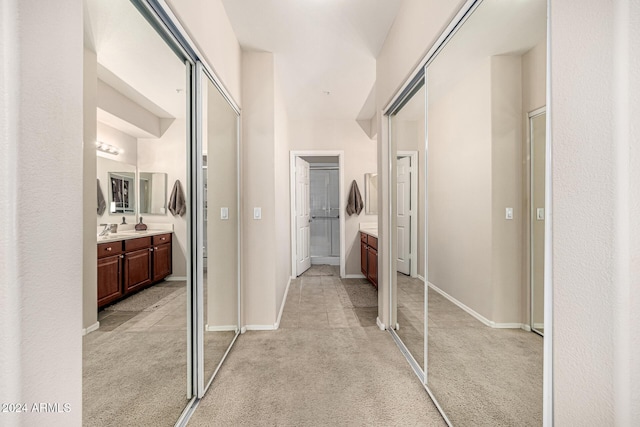 hall featuring light colored carpet