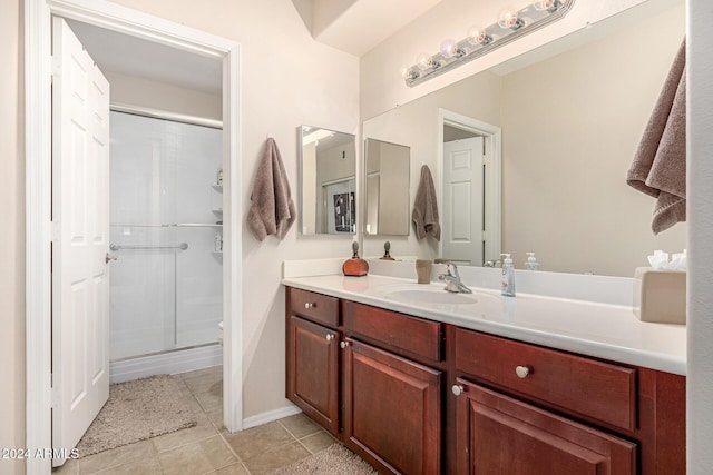 bathroom with vanity, tile patterned floors, and a shower with shower door