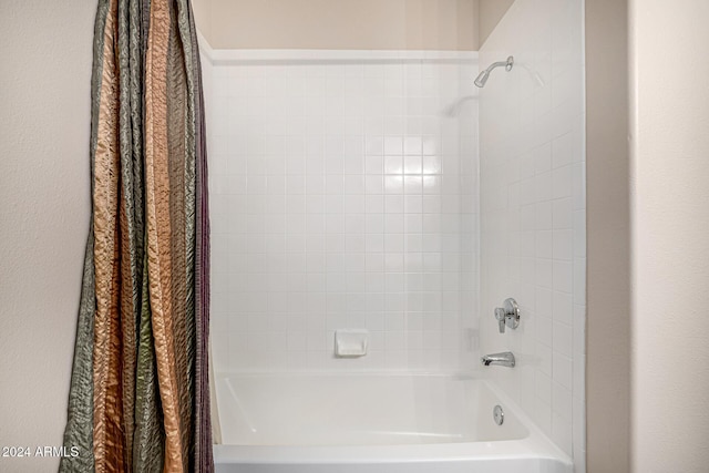 bathroom featuring shower / bathtub combination with curtain