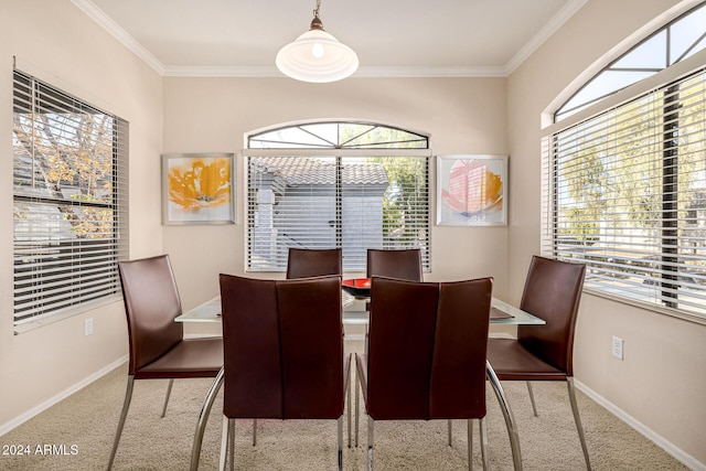 dining space featuring light colored carpet and ornamental molding