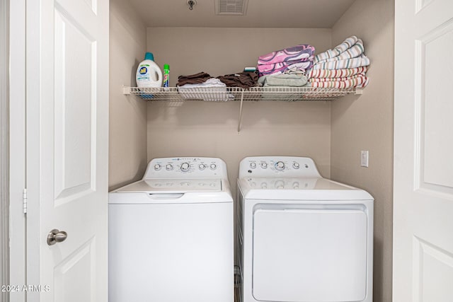 washroom with independent washer and dryer