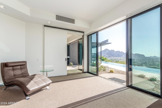 doorway to outside with a mountain view and carpet