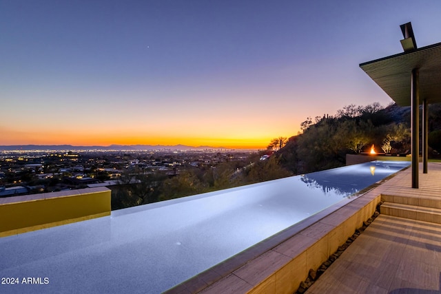 view of pool at dusk