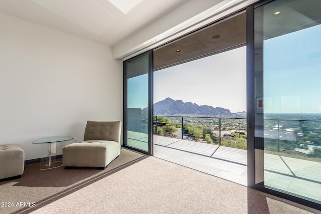 interior space with a mountain view, carpet floors, and a healthy amount of sunlight